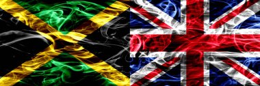 Jamaika vs İngiltere, İngiliz bayrakları yan yana yerleştirilmiş duman. Jamaika ve İngiltere, İngiliz ipeksi duman bayrakları renkli kalın