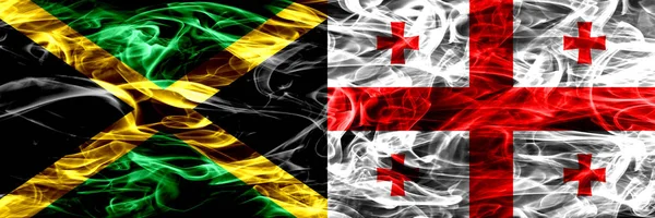 Jamaica vs Georgia, Georgian smoke flags placed side by side. Thick colored silky smoke flags of Jamaican and Georgia, Georgian