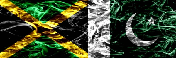 Jamaica vs Pakistan, Pakistani smoke flags placed side by side. Thick colored silky smoke flags of Jamaican and Pakistan, Pakistani