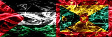 Palestine vs Grenada duman bayrakları yan yana yerleştirilmiş. Filistin ve Grenada ipeksi duman bayrakları renkli kalın