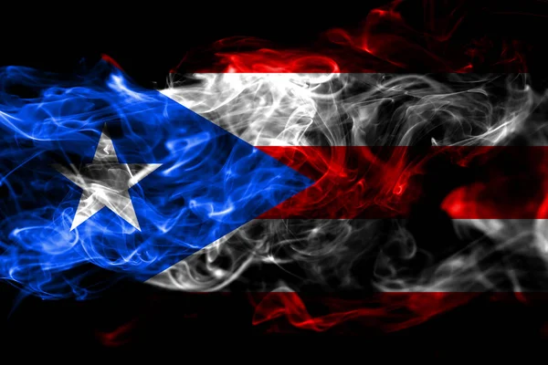 National flag of Puerto Rico made from colored smoke isolated on black background. Abstract silky wave background