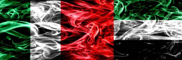 Italy vs United Arab Emirates, Emirati smoke flags placed side by side. Thick abstract colored silky smoke flags