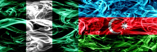 Nigeria, Nigerian vs Azerbaijan, Azerbaijani smoke flags placed side by side. Thick abstract colored silky smoke flags