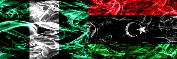ナイジェリア ナイジェリア対リビア リビア煙サイド サイド配置フラグ 厚い抽象的な色の絹のような煙のフラグ — ストック写真