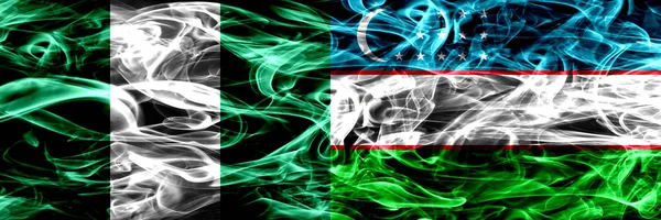 尼日利亚 尼日利亚对乌兹别克斯坦 乌兹别克烟火并排悬挂 厚重抽象的彩色丝质烟旗 — 图库照片