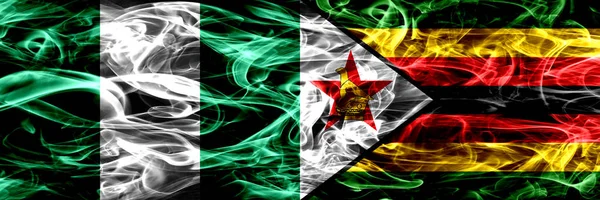 尼日利亚 尼日利亚 津巴布韦 津巴布韦的烟火并排放置 厚重抽象的彩色丝质烟旗 — 图库照片
