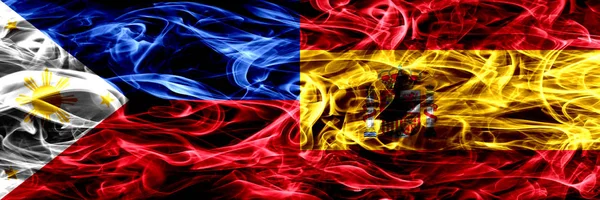 Philippines vs Spain, Spanish smoke flags placed side by side. Thick abstract colored silky smoke flags