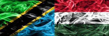 Tanzanya vs Macaristan, Macar bayrakları yan yana yerleştirilmiş duman. Kalın ipeksi duman bayrak Tanzanya ve Macaristan, Macarca, renkli