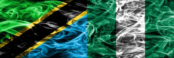 Tanzania vs Nigeria, Nigerian smoke flags placed side by side. Thick colored silky smoke flags of Tanzanian and Nigeria, Nigerian