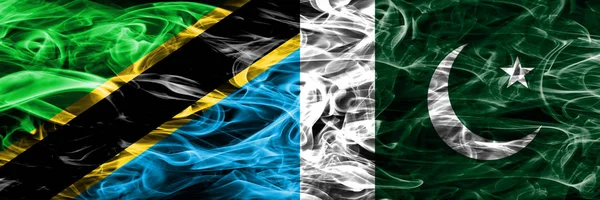 Tanzania vs Pakistan, Pakistani smoke flags placed side by side. Thick colored silky smoke flags of Tanzanian and Pakistan, Pakistani