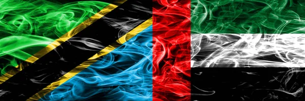 Tanzania vs United Arab Emirates, Emirati smoke flags placed side by side. Thick colored silky smoke flags of Tanzanian and United Arab Emirates, Emirati