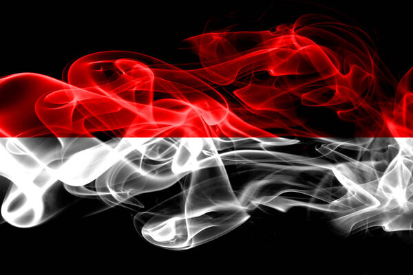 National flag of Indonesia made from colored smoke isolated on black background