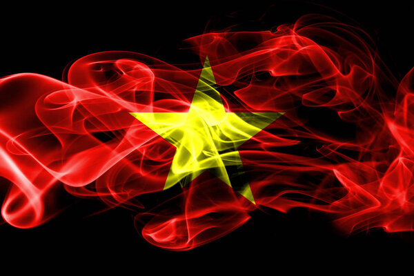 National flag of Vietnam made from colored smoke isolated on black background