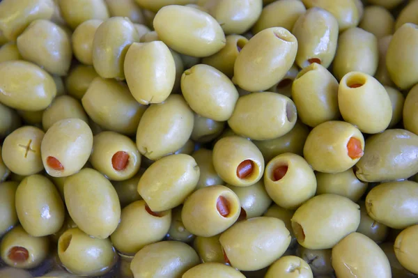 Green olives stuffed with red pepper background