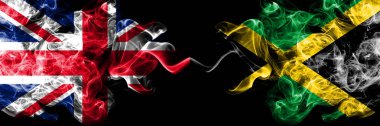 İngiltere vs Jamaika, Jamaika dumanlı mistik bayrakları yan yana yerleştirilmiş. Kalın ipeksi duman bayrak İngiltere ve Jamaika, Jamaika, renkli.