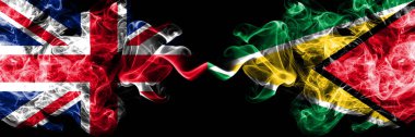 İngiltere vs Guyana, Guyanalı dumanlı mistik bayrakları yan yana yerleştirilmiş. İngiltere ve Guyana, Guyanalı ipeksi duman bayrakları kalın renkli.