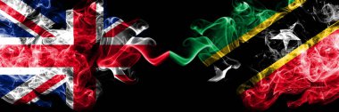 İngiltere vs Saint Kitts ve Nevis dumanlı mistik bayrakları yan yana yerleştirilmiş. Büyük Britanya ve Saint Kitts ve Nevis ipeksi duman bayrakları renkli kalın.