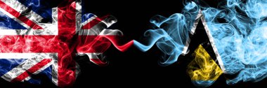 İngiltere vs Saint Lucia dumanlı mistik bayrakları yan yana yerleştirilmiş. Büyük Britanya ve Saint Lucia ipeksi duman bayrakları renkli kalın.