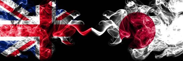 United Kingdom vs Japan, Japanese smoky mystic flags placed side by side. Thick colored silky smoke flags of Great Britain and Japan, Japanese. — Stock Photo, Image