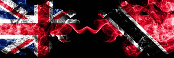 United Kingdom vs Trinidad and Tobago smoky mystic flags placed side by side. Thick colored silky smoke flags of Great Britain and Trinidad and Tobago. — Stock Photo, Image