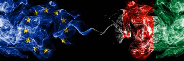 Europeiska unionen vs Afghanistan, Afghani rök flaggor placeras sida vid sida. Tjocka färgade silkes len rök flaggor i EU och Afghanistan, Afghani — Stockfoto