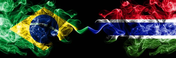 Brazil vs Gambia, Gambian smoke flags placed side by side. Thick colored silky smoke flags of Brazilian and Gambia, Gambian — Stock Photo, Image