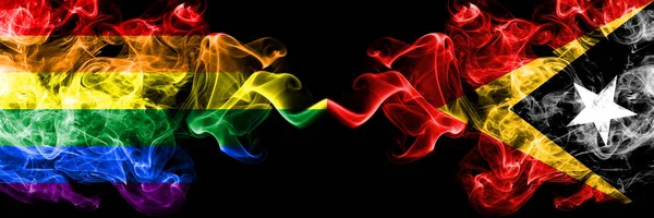 Gay vs East Timor smoke flags placed side by side. Thick colored silky smoke flags of Pride and East Timor — Stock Photo, Image