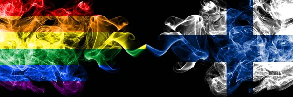 Gay vs Finlandia, banderas de humo FInnish colocadas lado a lado. Banderas de humo sedoso de color grueso de Orgullo y Finlandia, FInnish — Foto de Stock