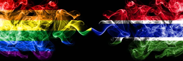 Gay vs Gambia, banderas de humo de Gambia colocadas lado a lado. Banderas de humo sedoso de color grueso de Orgullo y Gambia, Gambia — Foto de Stock