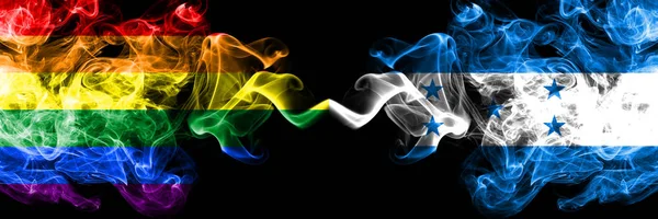 Gay vs Honduras, HONDURAN rök flaggor placeras sida vid sida. Tjocka färgade silkes len rök flaggor av Pride och Honduras, HONDURAN — Stockfoto