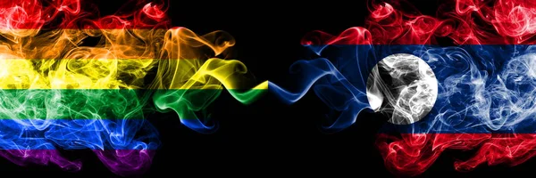 Bandeiras de fumo Gay vs Laos colocadas lado a lado. Bandeiras de fumo sedoso de cor grossa de Orgulho e Laos — Fotografia de Stock