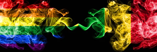 Gay vs Mali rök flaggor placeras sida vid sida. Tjocka färgade silkes len rök flaggor av Pride och Mali — Stockfoto