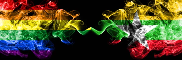Gay vs Myanmar rök flaggor placeras sida vid sida. Tjocka färgade silkes len rök flaggor av Pride och Myanmar — Stockfoto