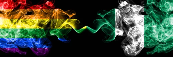 Gay vs Nigeria, Nigerian smoke flags placed side by side. Thick colored silky smoke flags of Pride and Nigeria, Nigerian — Stock Photo, Image