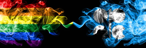 Gay vs OPEC flagi dymu umieszczone obok siebie. Grube kolorowe, jedwabiste flagi dymu dumy i OPEC — Zdjęcie stockowe