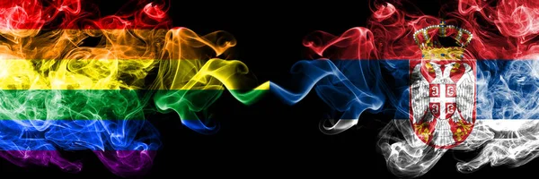 Gay vs Serbia, Serbian smoke flags placed side by side. Thick colored silky smoke flags of Pride and Serbia, Serbian — Stock Photo, Image