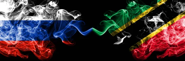 Русские против Сент-Китса и Невиса дымят флагами, расставленными рядом. Толстые шелковистые флаги России, Сент-Китса и Невиса — стоковое фото
