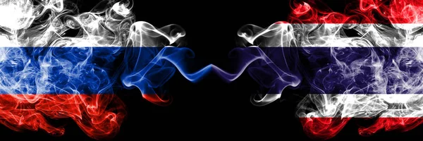 Russian vs Thailand, Thai smoke flags placed side by side. Thick colored silky smoke flags of Russia and Thailand, Thai