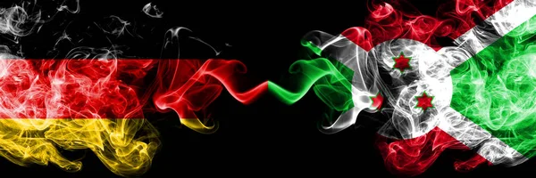 Germany vs Burundi, Burundian smoky mystic flags placed side by side. Thick colored silky smoke flags of Deutschland and Burundi, Burundian — Stock Photo, Image