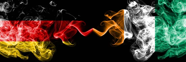 Germany vs Ivory Coast smoky mystic flags placed side by side. Thick colored silky smoke flags of Deutschland and Ivory Coast — Stock Photo, Image