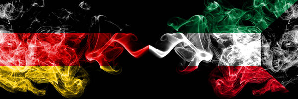 Germany vs Kuwait, Kuwaiti smoky mystic flags placed side by side. Thick colored silky smoke flags of Deutschland and Kuwait, Kuwaiti.