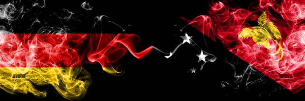 Germany vs Papua New Guinea smoky mystic flags placed side by side. Thick colored silky smoke flags of Deutschland and Papua New Guinea — Stock Photo, Image