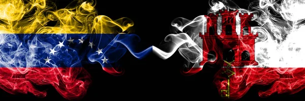 Venezuela vs Gibraltar smoky mystic flags placed side by side. Thick colored silky smoke flags of Venezuela and Gibraltar — Stock Photo, Image