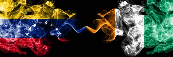 Venezuela vs Ivory Coast smoky mystic flags placed side by side. Thick colored silky smoke flags of Venezuela and Ivory Coast — Stock Photo, Image