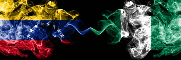 Venezuela vs Nigeria, Nigerian smoky mystic flags placed side by side. Thick colored silky smoke flags of Venezuela and Nigeria, Nigerian — Stock Photo, Image