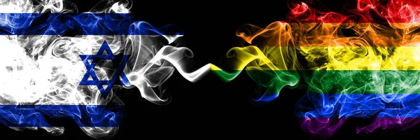 Israel vs Gay pride smoky mystic flags placed side by side. Thick colored silky smokes flag of Israel and Gay pride