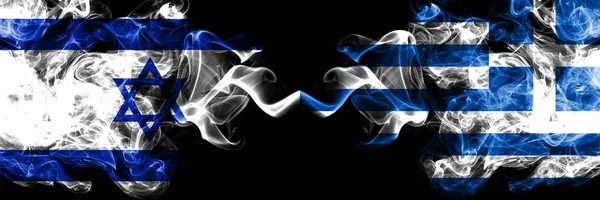 Израиль против Греции, греческие дымящиеся мистические флаги, помещенные бок о бок. Толстый шелковистый курит флаг Израиля и Греции, греческий — стоковое фото