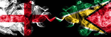 İngilizce vs Guyana, Guyanese dumanlı mistik bayraklar yan yana yerleştirilir. Kalın renkli ipeksi İngiltere ve Guyana, Guyana bayrağı dumanlar.