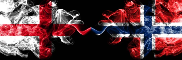 İngilizce vs Norveç, Norveç dumanlı mistik bayraklar yan yana yerleştirilir. Kalın renkli ipeksi İngiltere ve Norveç, Norveç bayrağı dumanlar. — Stok fotoğraf