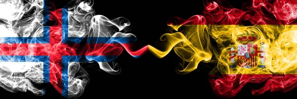 Faroe Islands, Spain, Spanish, flip competition thick colorful smoky flags. European football qualifications games — Stock Photo, Image